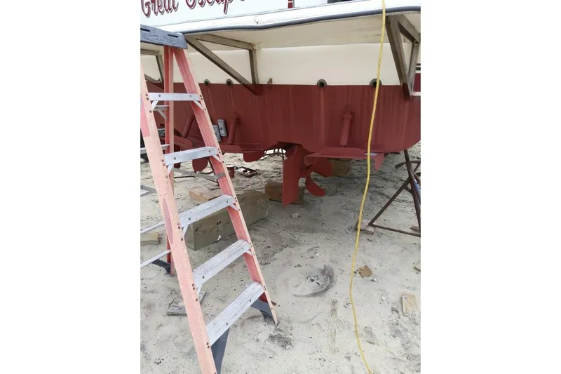  Yacht Photos Pics 1991 Bayliner 4588 Pilothouse boat under maintenance with ladder and tools nearby.