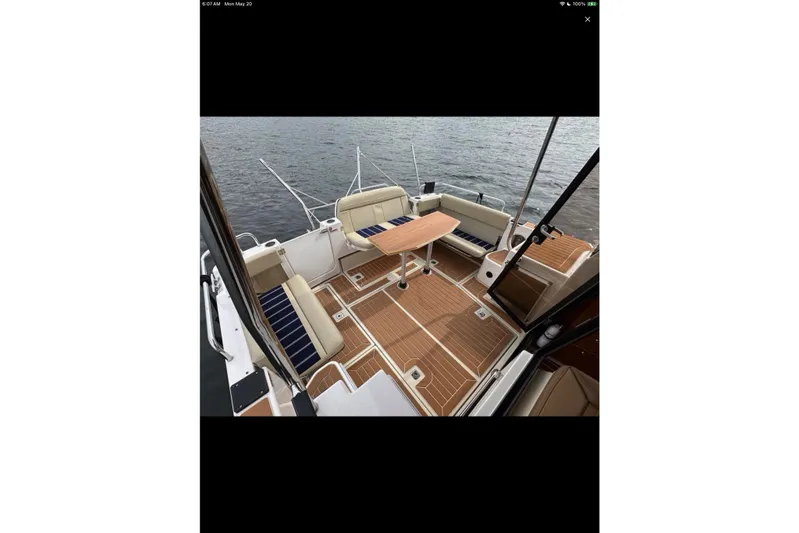 Flips Ahoy Yacht Photos Pics 2021 Ranger Tugs R-29 S boat deck with seating and table on the water.