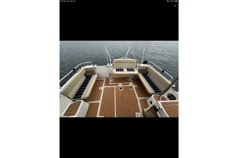 Flips Ahoy Yacht Photos Pics 2021 Ranger Tugs R-29 S boat deck with cushioned seating and wood flooring.