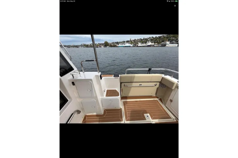 Flips Ahoy Yacht Photos Pics 2021 Ranger Tugs R-29 S boat deck with seating, storage, and scenic water view.