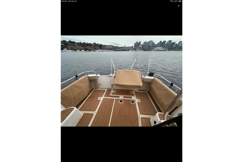 Flips Ahoy Yacht Photos Pics 2021 Ranger Tugs R-29 S boat deck with city skyline in background.