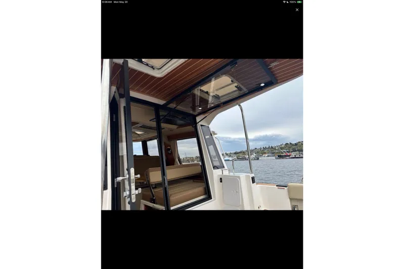 Flips Ahoy Yacht Photos Pics 2021 Ranger Tugs R-29 S boat interior with open door, overlooking a scenic waterfront.