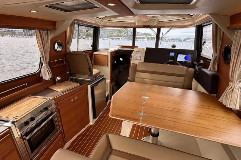 Flips Ahoy Yacht Photos Pics Luxurious interior of 2021 Ranger Tugs R-29 S boat with wood finishes and modern amenities.