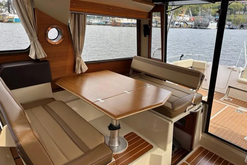 Flips Ahoy Yacht Photos Pics Interior of 2021 Ranger Tugs R-29 S boat with wooden table and seating.