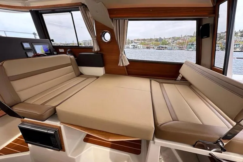 Flips Ahoy Yacht Photos Pics Interior of 2021 Ranger Tugs R-29 S with convertible seating and scenic water view.