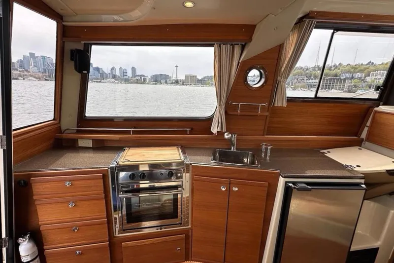 Flips Ahoy Yacht Photos Pics Interior of 2021 Ranger Tugs R-29 S with kitchen and city skyline view.