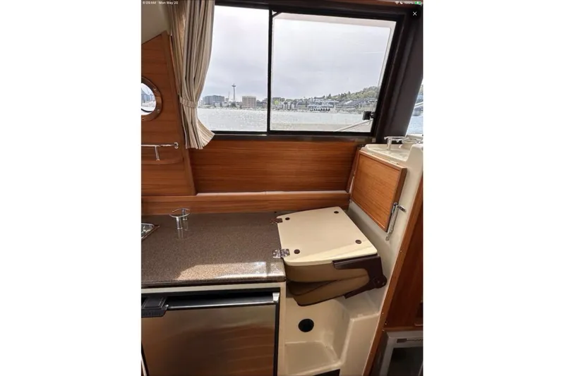 Flips Ahoy Yacht Photos Pics Interior of 2021 Ranger Tugs R-29 S boat with window view of cityscape.