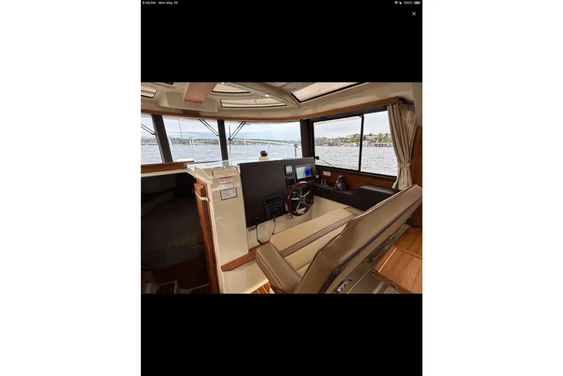 Flips Ahoy Yacht Photos Pics Interior of 2021 Ranger Tugs R-29 S boat with helm, navigation screens, and water view.