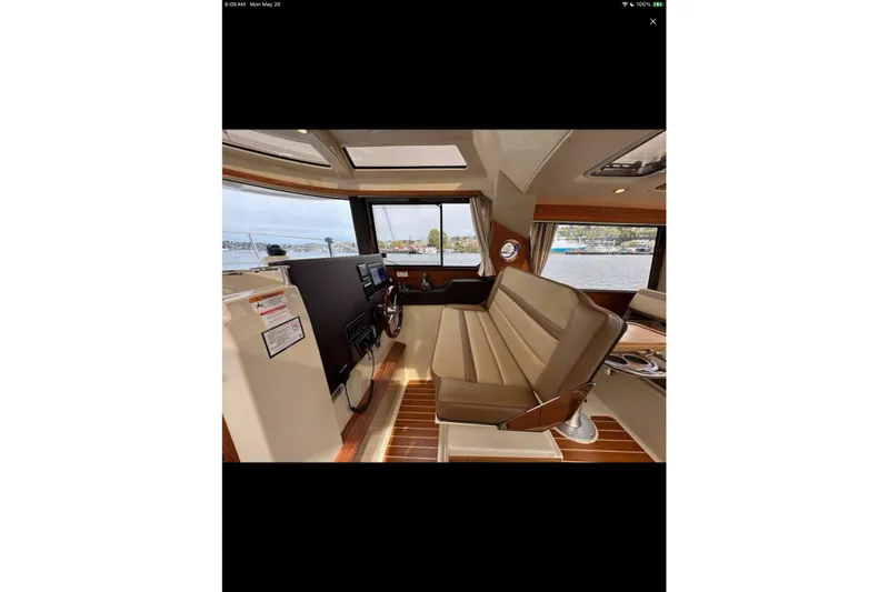 Flips Ahoy Yacht Photos Pics 2021 Ranger Tugs R-29 S interior with helm, seating, and panoramic windows.