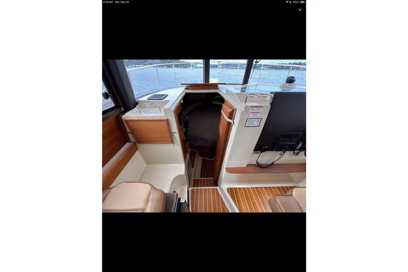 Flips Ahoy Yacht Photos Pics 2021 Ranger Tugs R-29 S interior with wood accents and cabin view.