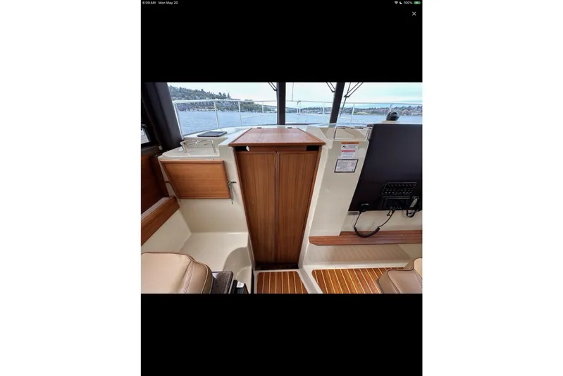 Flips Ahoy Yacht Photos Pics Interior view of 2021 Ranger Tugs R-29 S boat with wood accents and seating.