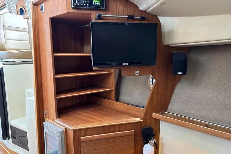 Flips Ahoy Yacht Photos Pics 2021 Ranger Tugs R-29 S interior with wooden shelves, TV, and speaker.