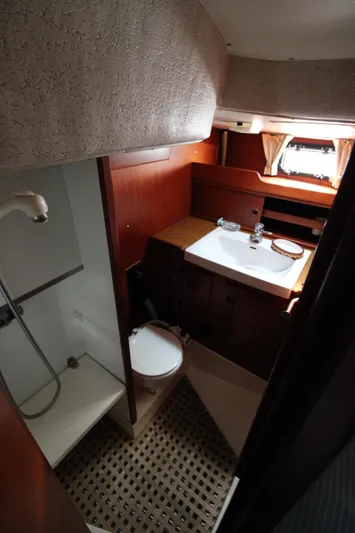  Yacht Photos Pics 1988 Hallberg-Rassy 42 yacht bathroom with shower, sink, and wooden cabinetry.