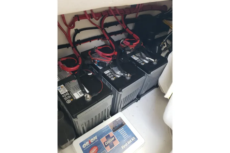 27 Albury Brothers Yacht Photos Pics Batteries and wiring inside a 2022 Albury Brothers 27 boat, with a first aid kit nearby.
