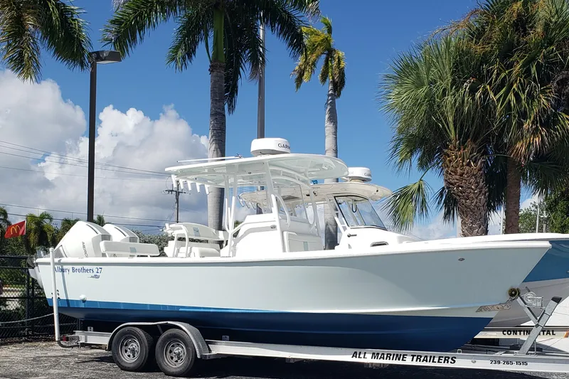 27 Albury Brothers Yacht Photos Pics 2022 Albury Brothers 27 boat on trailer, surrounded by palm trees.