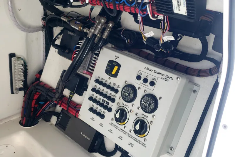 27 Albury Brothers Yacht Photos Pics Electrical panel of a 2022 Albury Brothers 27 boat, showcasing wiring and controls.