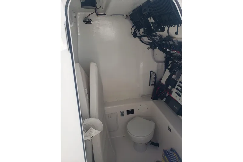 27 Albury Brothers Yacht Photos Pics 2022 Albury Brothers 27 boat interior with toilet and electrical panel.