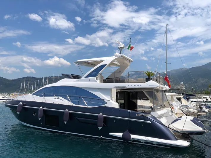  Yacht Photos Pics 2018 Azimut 55 yacht docked in a marina under a clear blue sky.