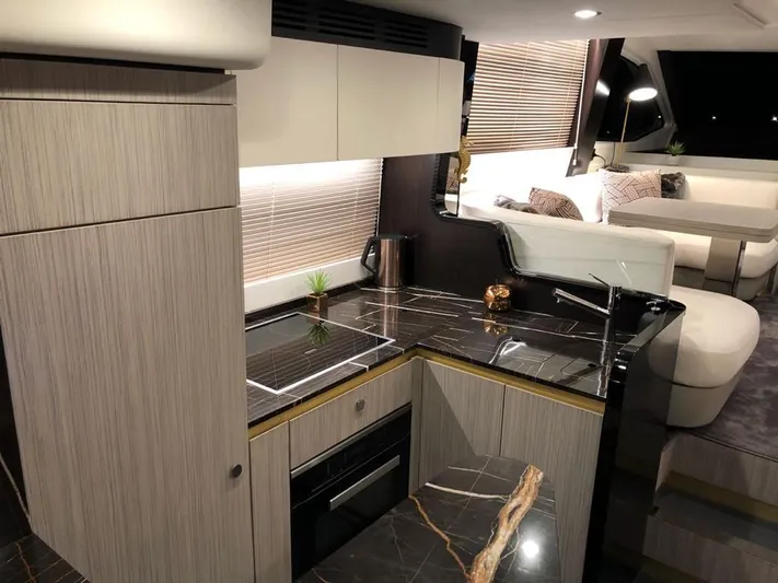  Yacht Photos Pics Luxurious interior of a 2018 Azimut 55 yacht featuring a modern kitchen and seating area.