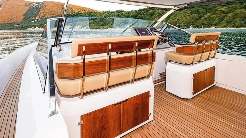  Yacht Photos Pics 2024 Franchini 63 yacht interior with elegant wood and leather seating, overlooking scenic waters.