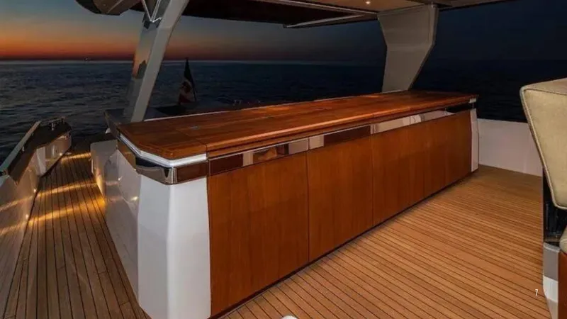  Yacht Photos Pics Luxurious 2024 Franchini 63 yacht deck with elegant wooden bar at sunset.