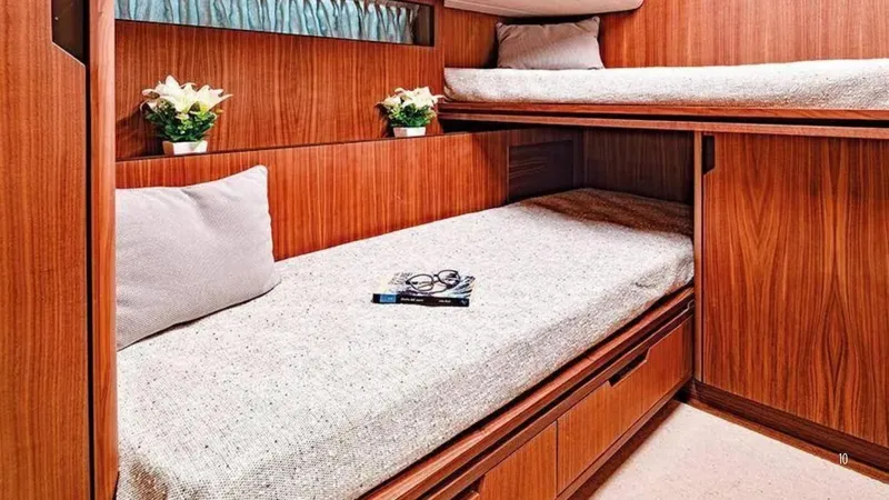  Yacht Photos Pics Luxurious 2024 Franchini 63 yacht cabin with wooden interior and cozy bedding.