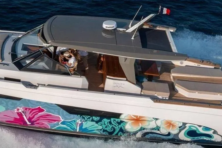  Yacht Photos Pics 2024 Franchini 63 yacht with vibrant floral hull design cruising on the ocean.