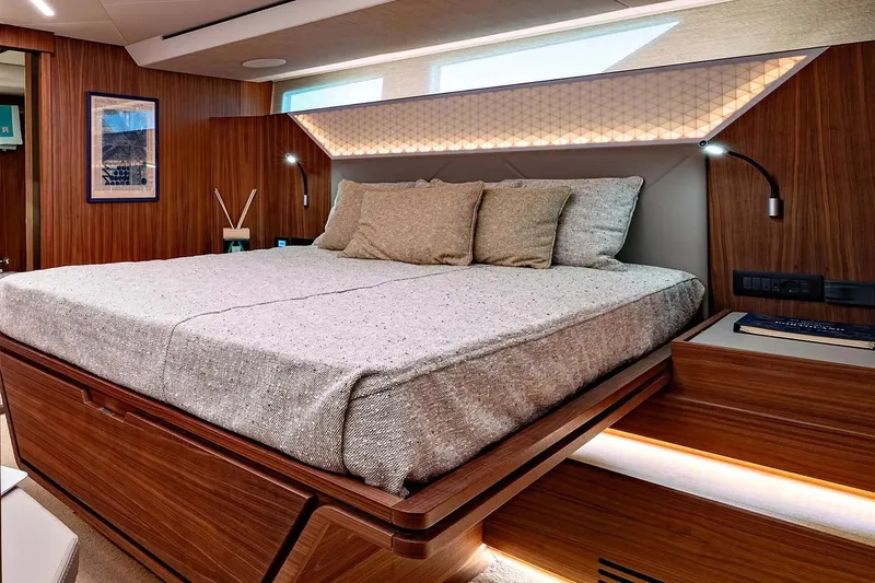  Yacht Photos Pics Luxurious bedroom interior of 2024 Franchini 63 yacht with modern wood finish and ambient lighting.