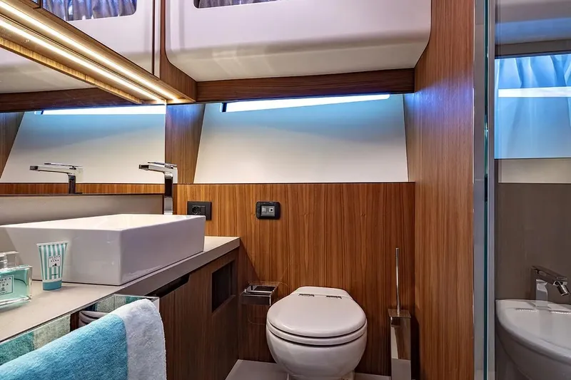  Yacht Photos Pics Luxurious bathroom interior of 2024 Franchini 63 yacht with modern fixtures and wood accents.