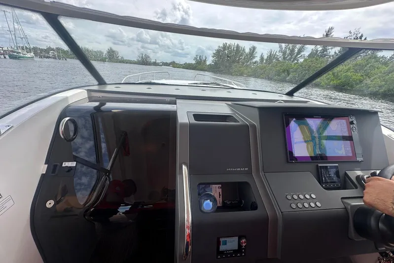  Yacht Photos Pics Interior view of 2025 Nimbus Tender 11 boat with navigation system and steering wheel.