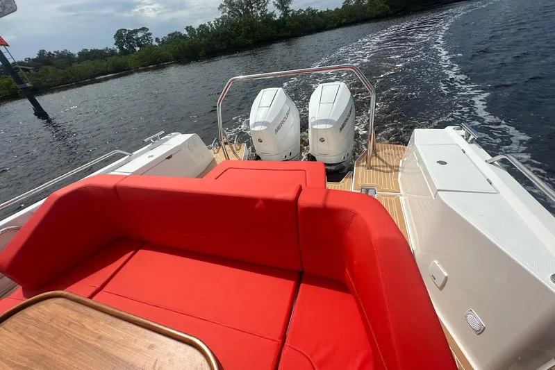  Yacht Photos Pics Red seating on 2025 Nimbus Tender 11 boat with dual outboard motors on water.