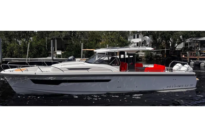  Yacht Photos Pics 2025 Nimbus Tender 11 boat with sleek design and vibrant red seating.