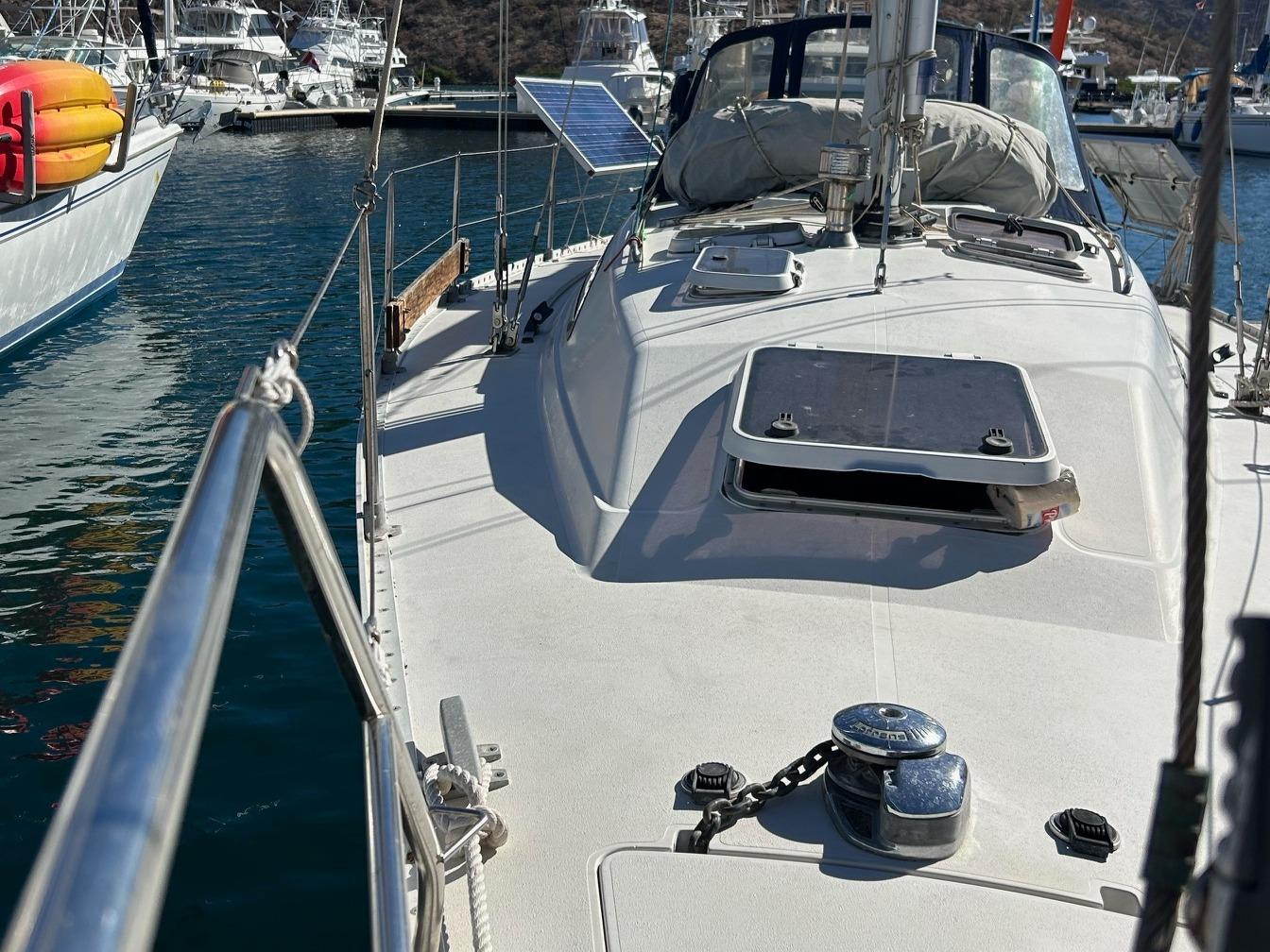 1988 CS 36 Merlin sailboat docked in marina, featuring deck and hatch view.