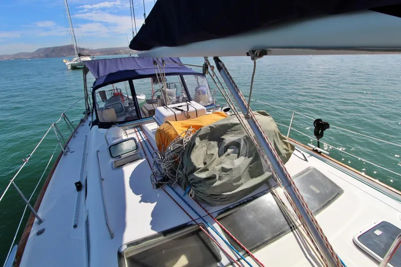  Yacht Photos Pics 2003 Beneteau 473 sailboat deck with ropes and equipment, anchored on calm water.