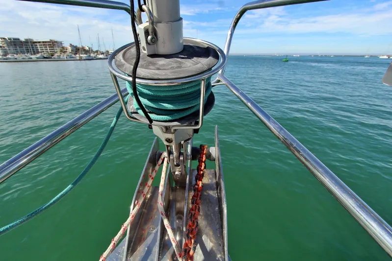  Yacht Photos Pics Bow of 2003 Beneteau 473 sailboat with anchor chain and winch, docked in marina.
