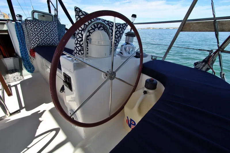  Yacht Photos Pics Steering wheel of a 2003 Beneteau 473 sailboat with nautical decor and ocean view.