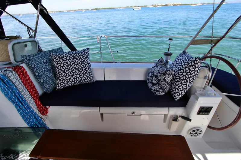  Yacht Photos Pics 2003 Beneteau 473 sailboat cockpit with patterned cushions and ocean view.