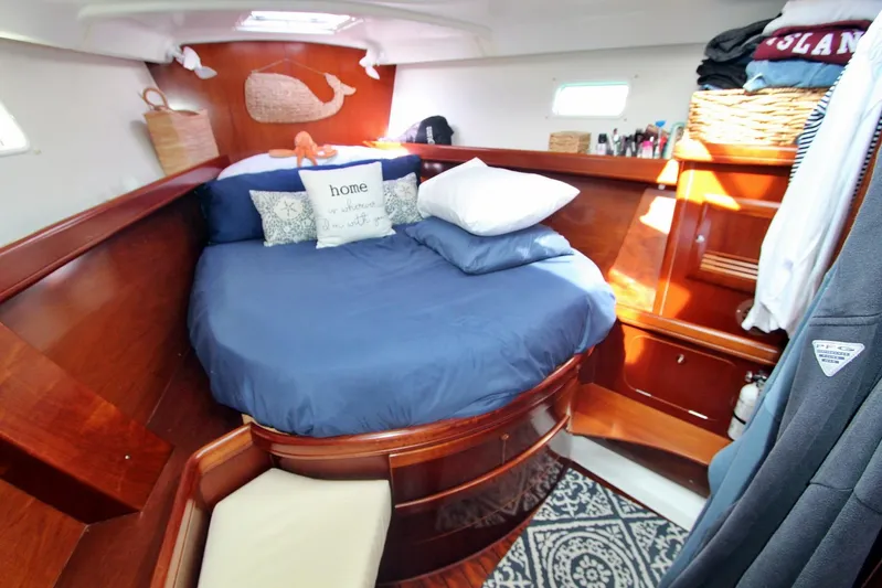  Yacht Photos Pics Luxurious cabin interior of 2003 Beneteau 473 yacht with cozy bedding and wooden finish.