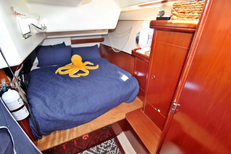  Yacht Photos Pics Cozy cabin interior of 2003 Beneteau 473 yacht with plush bedding and wooden cabinetry.