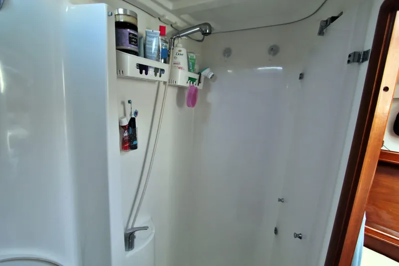  Yacht Photos Pics Shower area in a 2003 Beneteau 473 yacht, featuring toiletries and a handheld showerhead.