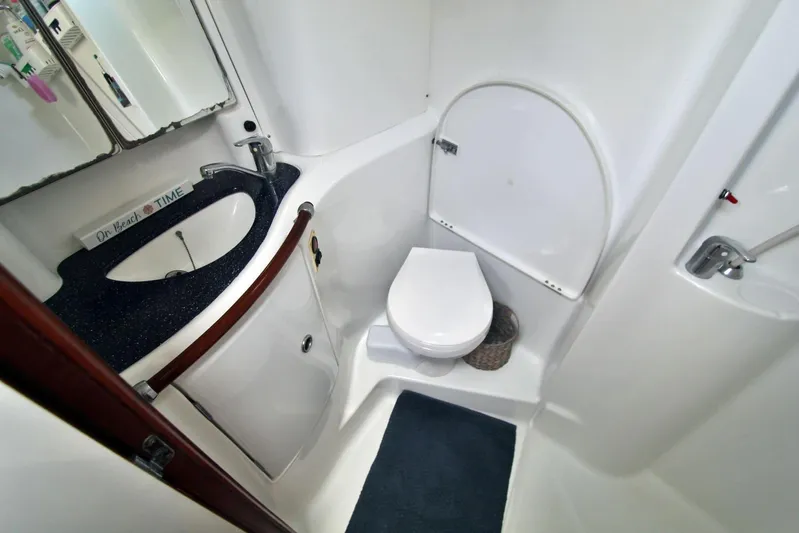  Yacht Photos Pics 2003 Beneteau 473 yacht bathroom with sink, toilet, and shower.