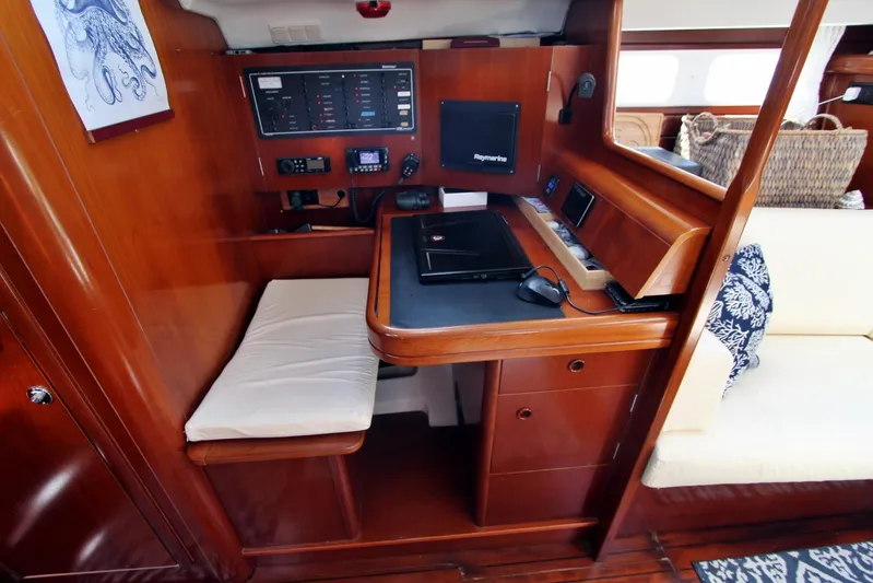  Yacht Photos Pics Navigation station in 2003 Beneteau 473 yacht with control panel and seating.