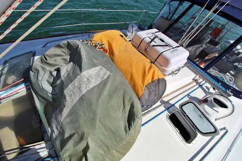  Yacht Photos Pics Deck of 2003 Beneteau 473 sailboat with covered equipment and life raft.