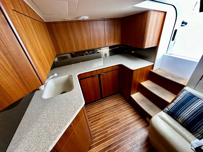 Shangri-la-de-dah Yacht Photos Pics 2005 Viking 45 Open Express yacht kitchen with wooden cabinets and countertops