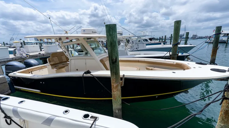  Yacht Photos Pics 2016 Scout 350 LXF boat docked at marina, featuring sleek design and spacious deck.