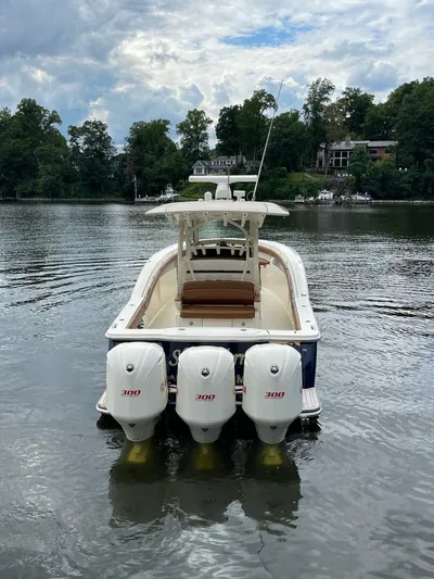  Yacht Photos Pics 2016 Scout 350 LXF boat with triple 300 horsepower engines on a calm lake.