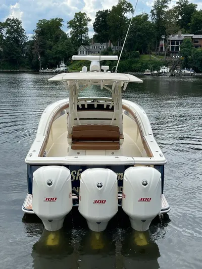 Yacht Photos Pics 2016 Scout 350 LXF boat with triple 300 horsepower engines on a calm lake.