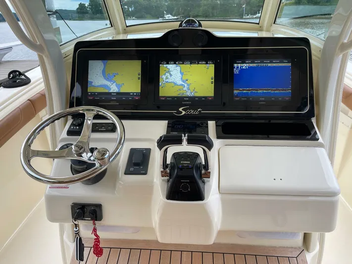 Yacht Photos Pics 2016 Scout 350 LXF boat dashboard with navigation screens and steering wheel.