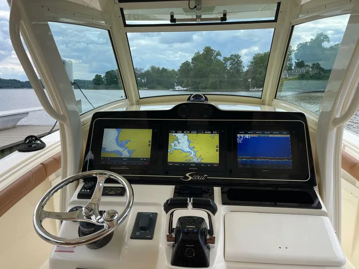 Yacht Photos Pics 2016 Scout 350 LXF boat dashboard with navigation screens and steering wheel.