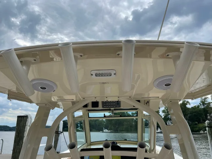  Yacht Photos Pics 2016 Scout 350 LXF boat with rod holders and speakers under cloudy sky.